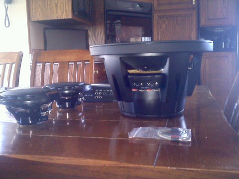 1993 Ford Probe - Car audio equipment including subwoofers and an amplifier are displayed on a wooden table.