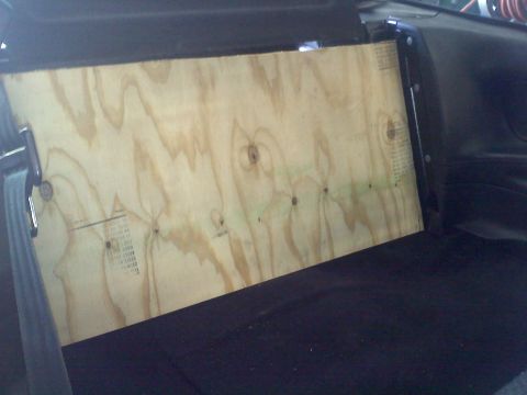 1993 Ford Probe - A piece of plywood has been installed inside a vehicle, obscuring the view of the interior.
