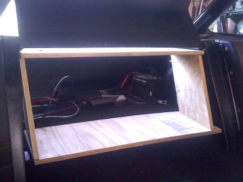 1993 Ford Probe - A custom-built wooden shelf is installed in the cargo area, with wiring and electronic components visible behind it.