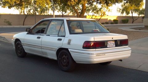 1993 Mercury Tracer - White 1993 Mercury Tracer sedan parked outdoors, showing its rear and side profile.