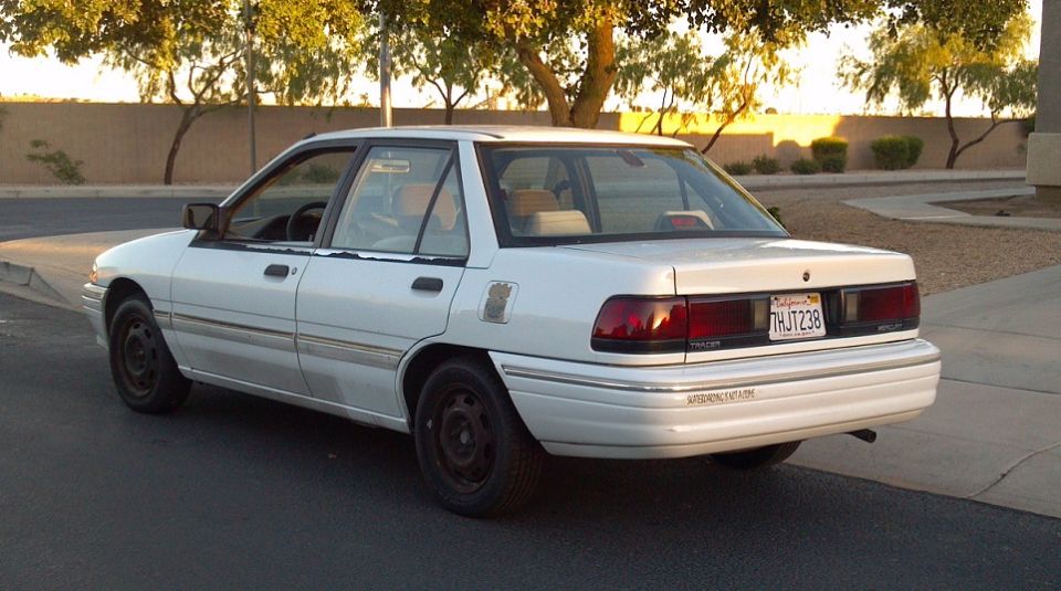 1993 Mercury Tracer sedan, rear 3/4 view. License plate THJ238