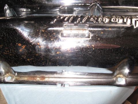 1963 Ford Galaxie - Close-up of a chrome trim piece with visible rust and wear.