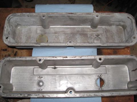 1963 Ford Galaxie - Two aluminum valve covers are shown, one placed on top of the other, with visible signs of age and use.