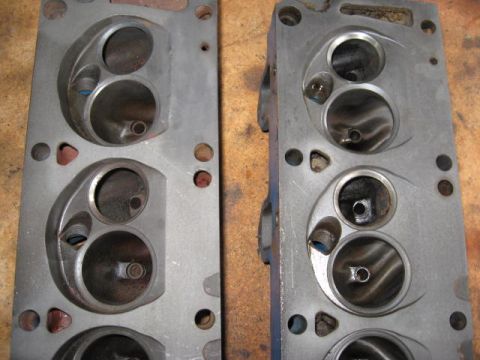 1963 Ford Galaxie - Close-up view of two engine cylinder heads, showing their internal port structure and metal construction.