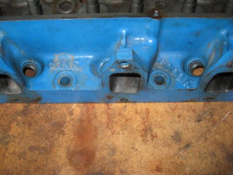 1963 Ford Galaxie - Engine cylinder head with visible casting numbers C9AE and 8090. Part is painted blue.