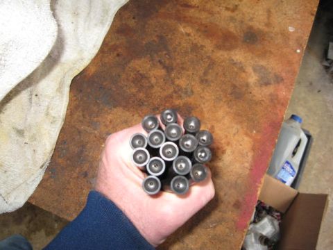 1963 Ford Galaxie - A hand holds a group of valve lifters, likely for an engine rebuild or repair.