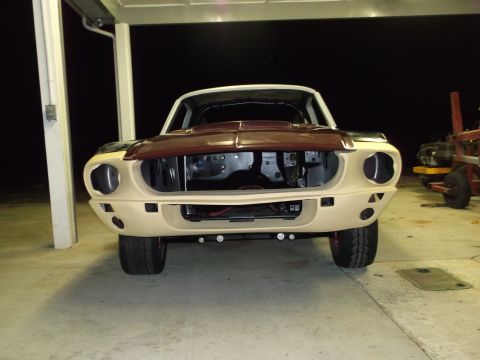 1967 Ford Mustang - This 1967 Ford Mustang is in the process of being restored, missing its grille and with the hood open.