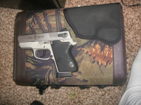 1999 Squire ST3 - A Smith & Wesson Chief's Special pistol rests on a camouflage patterned case.