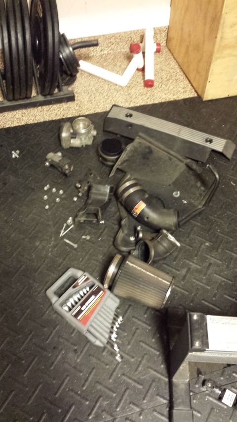 2002 BMW 3 Series - Disassembled engine components are laid out on a textured mat next to a set of tools.