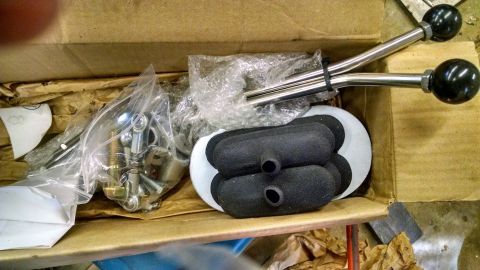 1979 Ford F-150 - New shift levers and hardware are packed in a cardboard box for shipping.