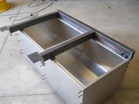 1992 Ford Bronco - Custom metal tanks are being fabricated with a steel frame structure in a workshop.