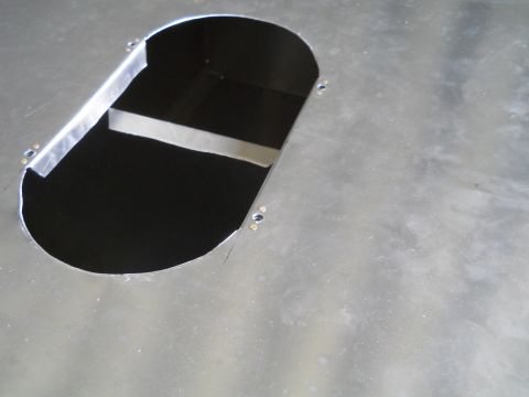 1992 Ford Bronco - Close-up of a metal panel with a cut opening and visible bracing inside.