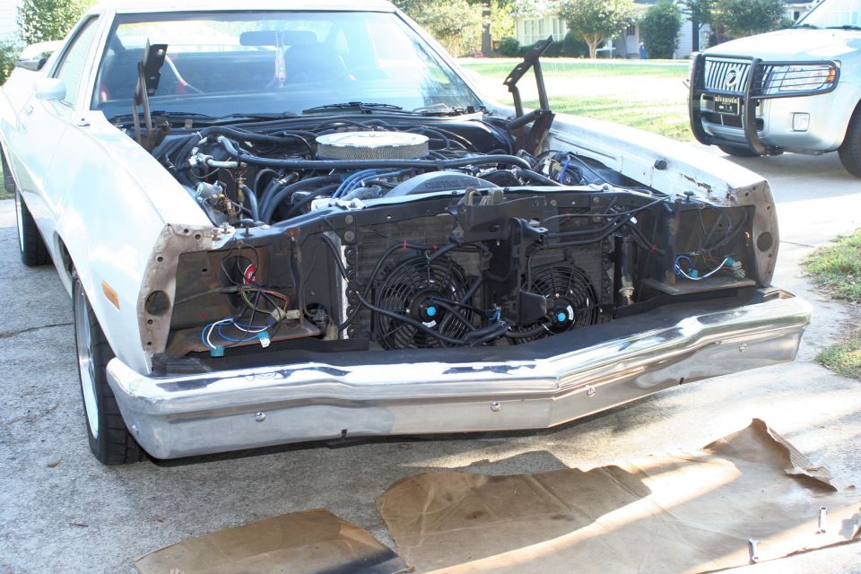 White 1976 Ford Ranchero engine bay with hood open, showing fans and wiring