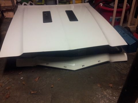 1976 Ford Ranchero - A white hood with two black vents and the letters F O R D are visible on the underside.