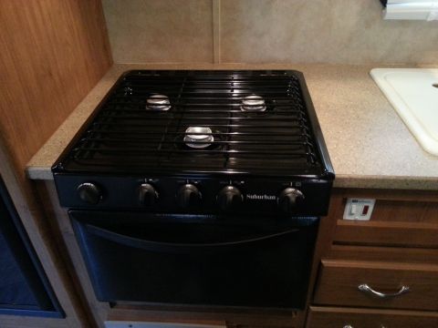 1967 Ford Mustang - A black Suburban brand stove and oven unit is installed in an RV kitchen counter.