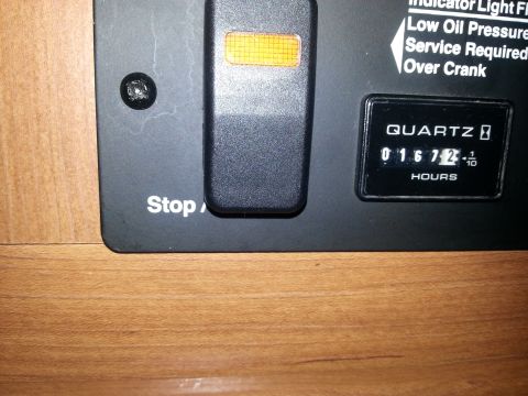 1967 Ford Mustang - Close-up of a dashboard panel displaying an hour meter and a switch.