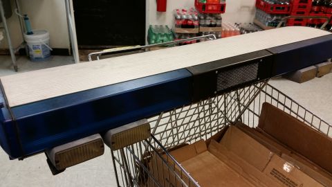 2001 Ford Crown Victoria - A blue and white light bar, likely for a vehicle, is seen resting on a shopping cart in what appears to be a storage area.