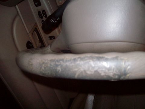 2004 Ford Crown Victoria - Interior view of a worn steering wheel from a 2004 Ford Crown Victoria.
