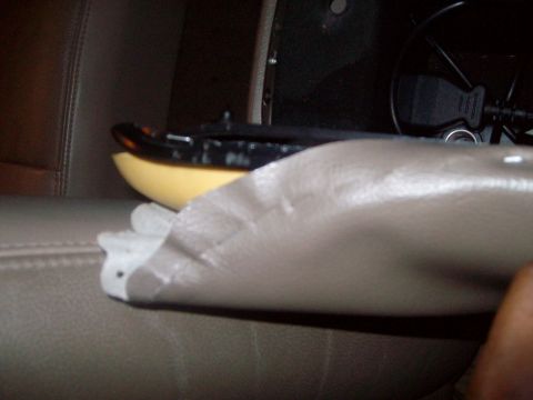 2004 Ford Crown Victoria - Close-up of a car's interior, focusing on a detached trim piece and a connected USB adapter.