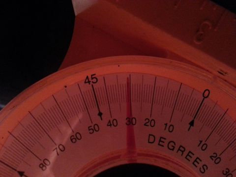 1995 Ford Bronco - A close-up of an orange degree gauge shows markings from 0 to 90 degrees.