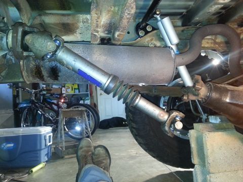 1995 Ford Bronco - Close-up view of vehicle drivetrain components including driveshaft and exhaust system.
