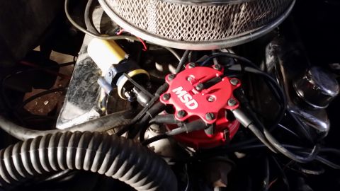 1983 Ford Bronco - Close-up view of engine components including a red MSD distributor cap and yellow ignition coil.