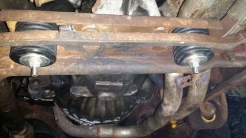 1983 Ford Bronco - This image shows the underbody of a vehicle, focusing on suspension mounts and exhaust components. The registry claims it is a 1983 Ford Br…
