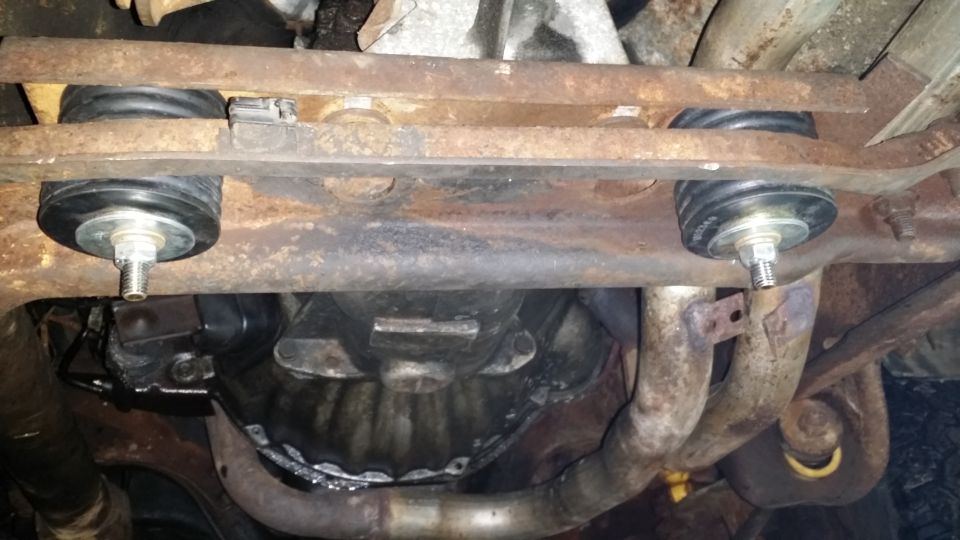 Underbody view of vehicle suspension mounts and exhaust system