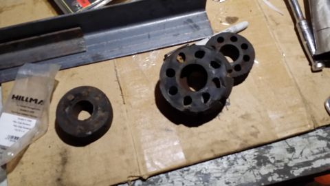 1983 Ford Bronco - Rubber isolators and metal parts laid out on cardboard, with a bag of Hillman parts.