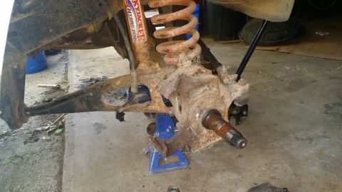 1983 Ford Bronco - This image shows a heavily rusted front suspension component, likely from an older vehicle undergoing repair.
