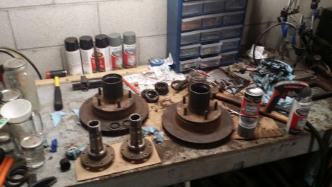 1983 Ford Bronco - Vehicle brake components laid out on a workbench, possibly for repair or maintenance.