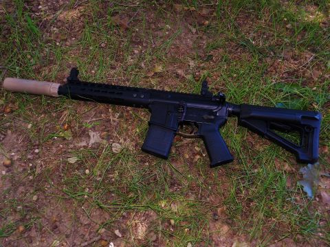 1996 Ford Bronco - A black assault rifle with a tan suppressor is visible on the ground.