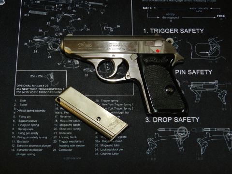 1996 Ford Bronco - A Walther PPK pistol and its magazine are displayed on a mat with firearm schematics.