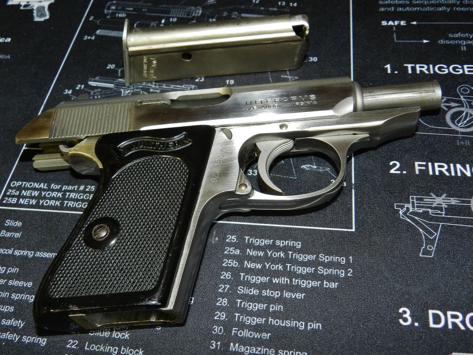 Pistol with magazine on a gun mat with parts list