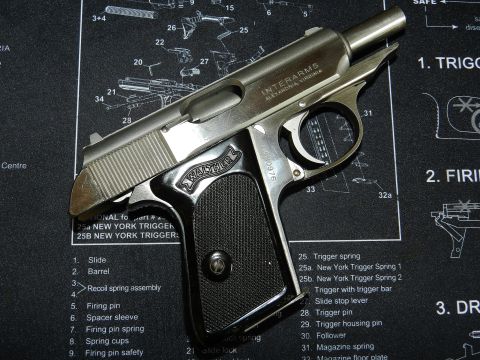 1996 Ford Bronco - A close-up view of an Interarms Walther pistol resting on a mat with gun schematics.
