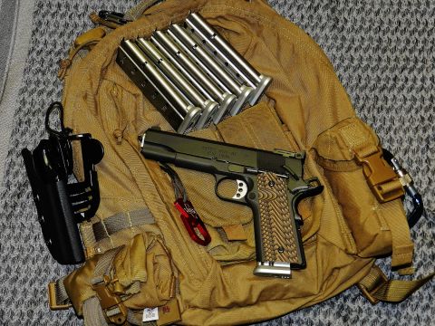 1996 Ford Bronco - Pistol and magazines are laid out on a tactical backpack.
