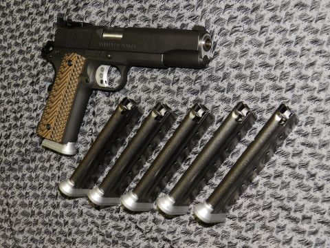 1996 Ford Bronco - Springfield RO 1911 pistol and five magazines laid out on a patterned surface.