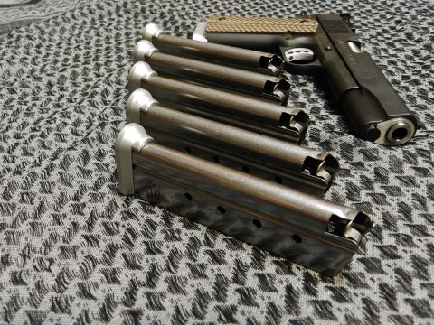 1996 Ford Bronco - A Springfield RO 1911 9mm pistol is shown with five spare magazines arranged in a row.