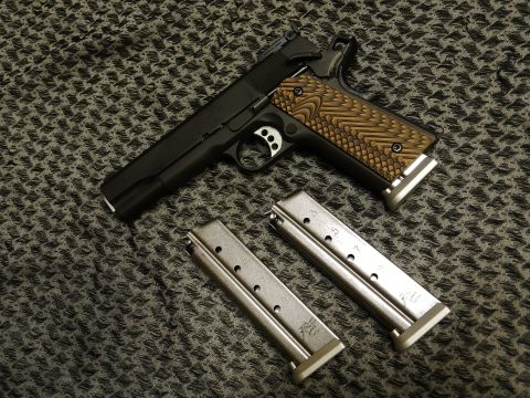 1996 Ford Bronco - A pistol and its magazines are displayed on a patterned surface.