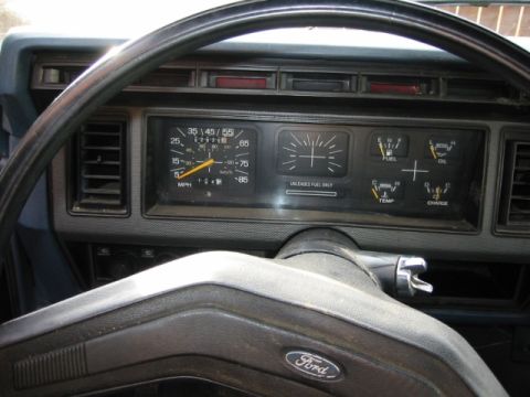1985 Ford Bronco - Interior view of a 1985 Ford Bronco dashboard, showing gauges and steering wheel.