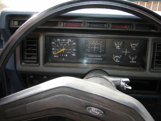 1985 Ford Bronco dashboard with speedometer, fuel gauge, oil pressure, temperature, and charge indicators