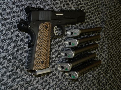 1996 Ford Bronco - Pistol with custom grips and five magazines are laid out on a patterned surface.