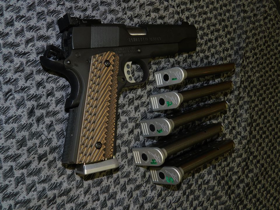 Pistol with custom grips and five magazines, some with green markings