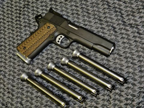 1996 Ford Bronco - A Springfield RO 1911 9mm pistol and its magazines are displayed on a textured background.
