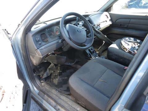 2001 Ford Crown Victoria - The interior of a 2001 Ford Crown Victoria, its dashboard, steering wheel, and front seats.