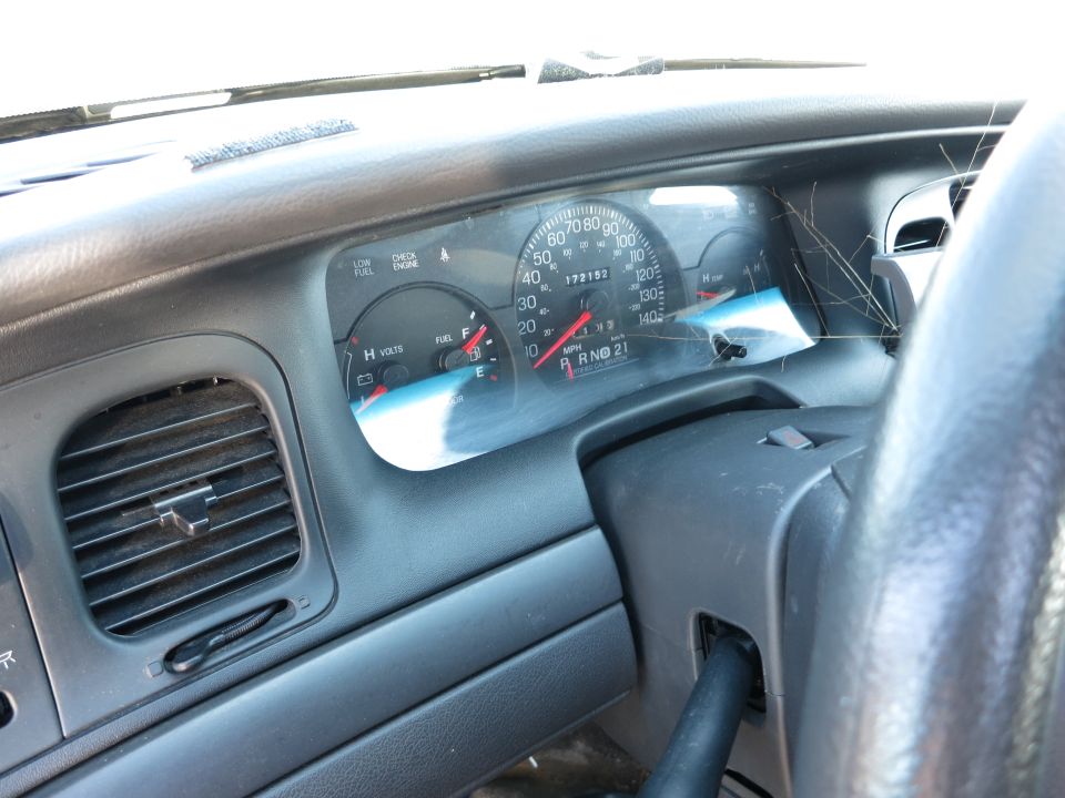 Dashboard interior of a 2001 Ford Crown Victoria showing the speedometer, fuel gauge, and air vents