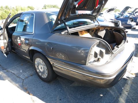 2001 Ford Crown Victoria - This 2001 Ford Crown Victoria is seen with its trunk and driver door ajar, revealing its interior and some cargo.