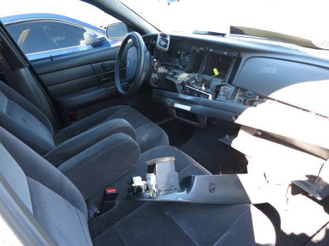 2001 Ford Crown Victoria - The interior of a car shows a disassembled dashboard with exposed wiring and components.