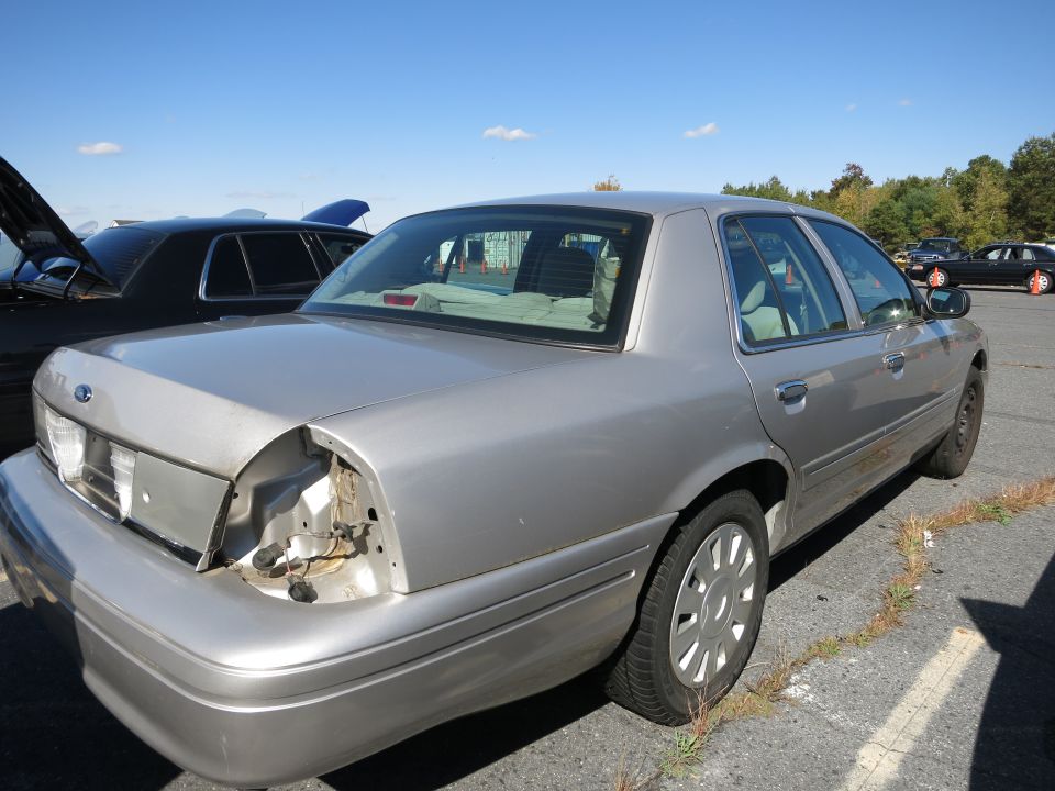 Silver 2001 Ford Crown Victoria, rear view, missing taillight