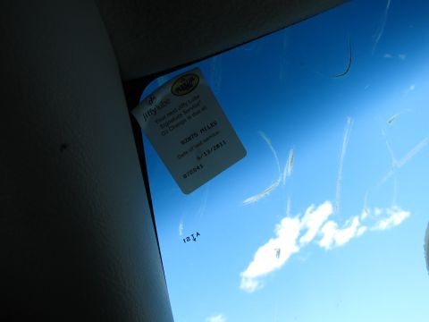 2001 Ford Crown Victoria - Photograph of a Jiffy Lube service-reminder decal stuck to a windshield, a reminder sticker rather than a technical document.